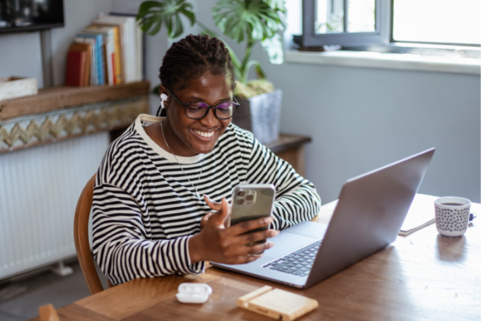 An entrepreneur celebrating passive income, showcasing what are the advantages of selling digital products.